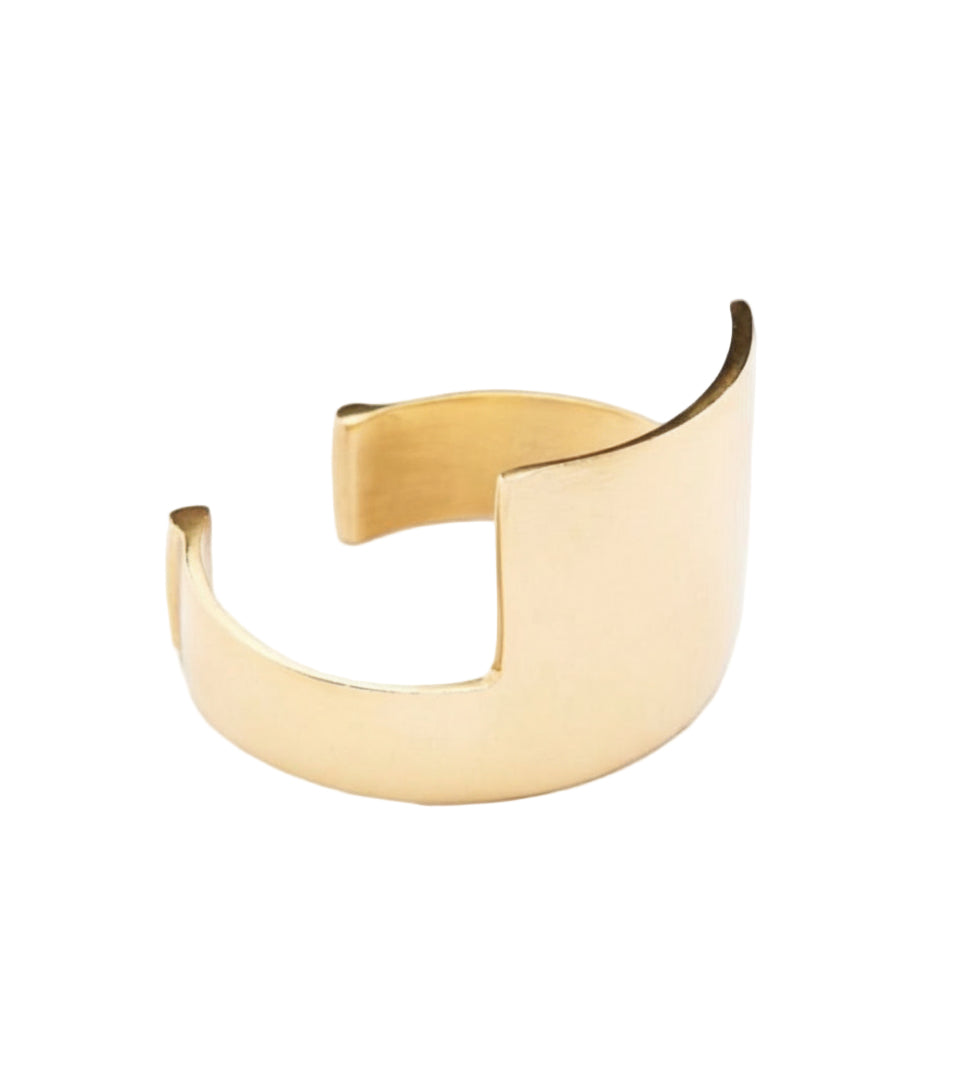 Gold cuff bracelet on a white background with 'Caramel Cuff' text above.