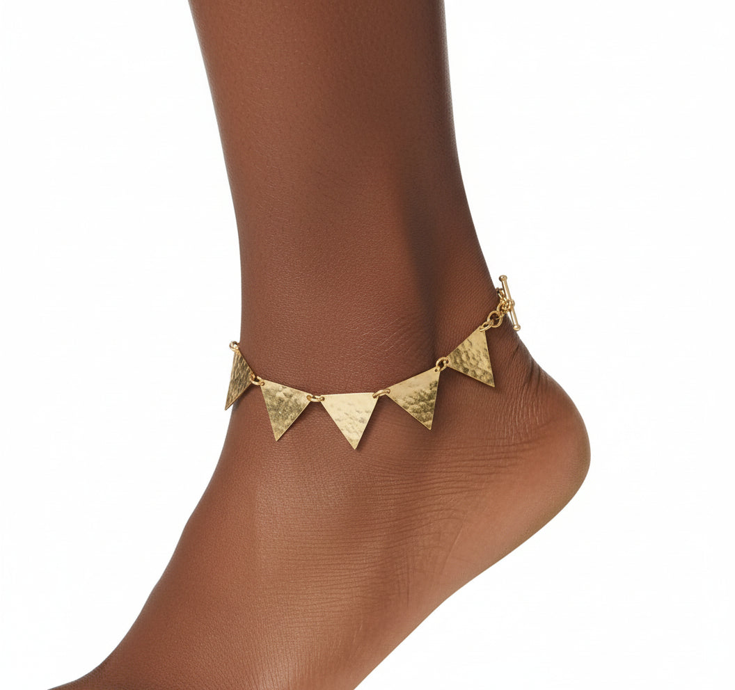 Gold bracelet with triangular pendants on a white background